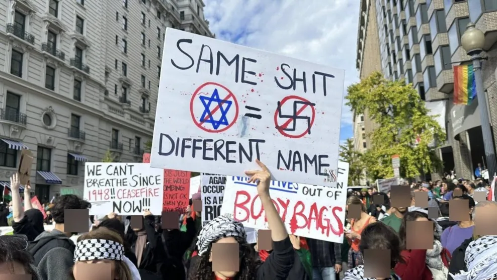 Photo; Washington, DC -- A protestor held a sign equating a Star of David and a Nazi Swastika in November.